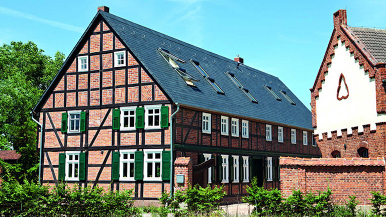Stary wyremontowany dom z muru pruskiego z kilkoma wbudowanymi świetlikami